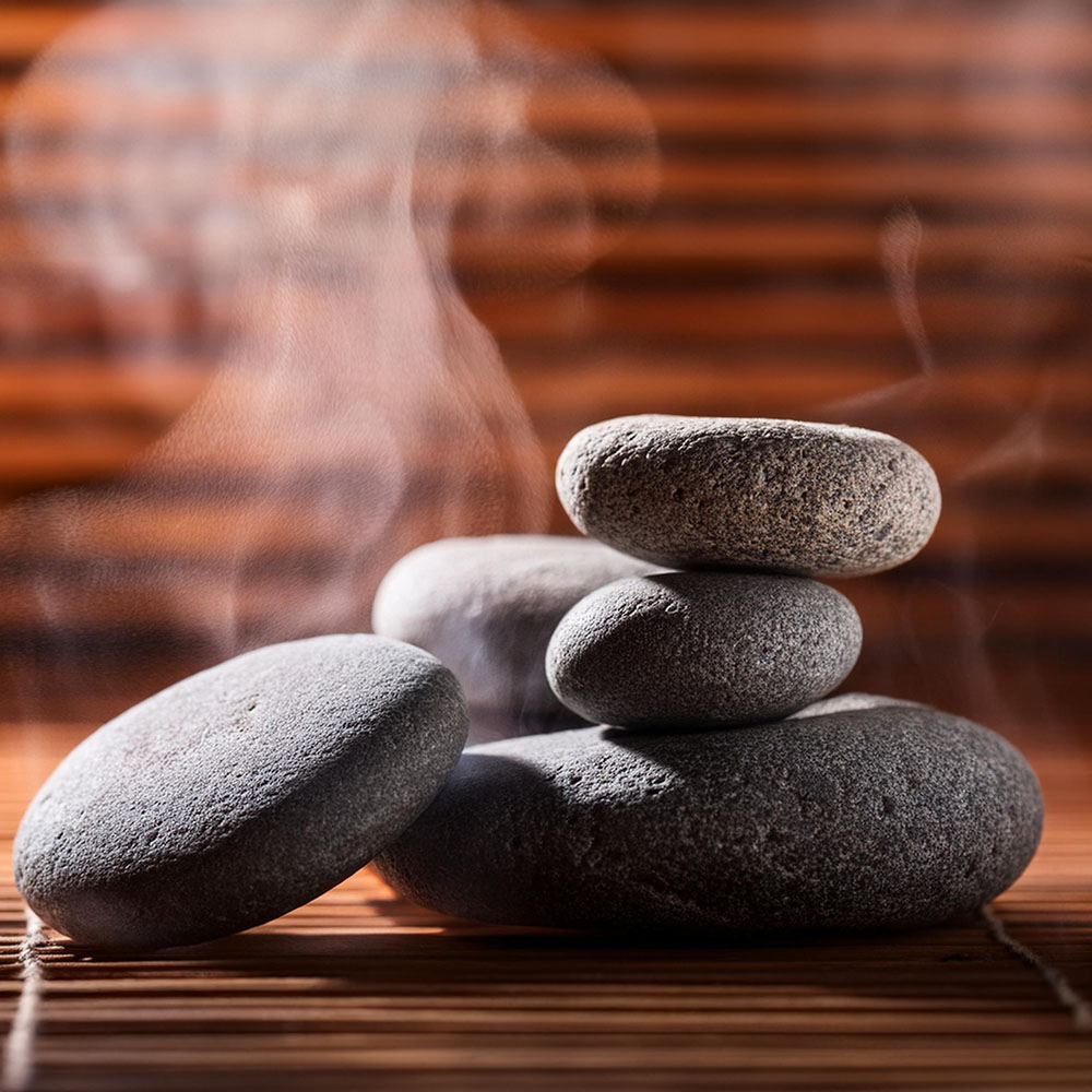 Steaming hot massage lava stones, stacked upon each other.